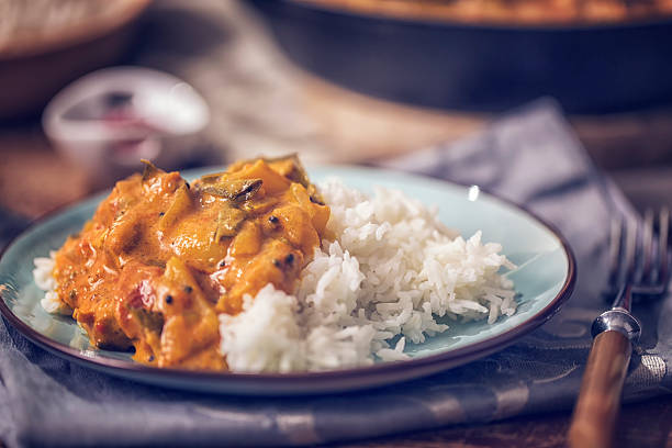 Delicous Homemade Chicken Curry Dish with Rice Delicious homemade chicken curry dish with basmati rice served on a plate. tomato rice stock pictures, royalty-free photos & images