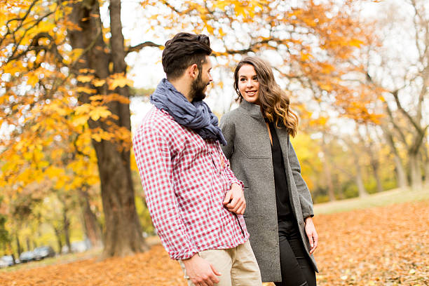 istock Young couple in the autumn park 511873764