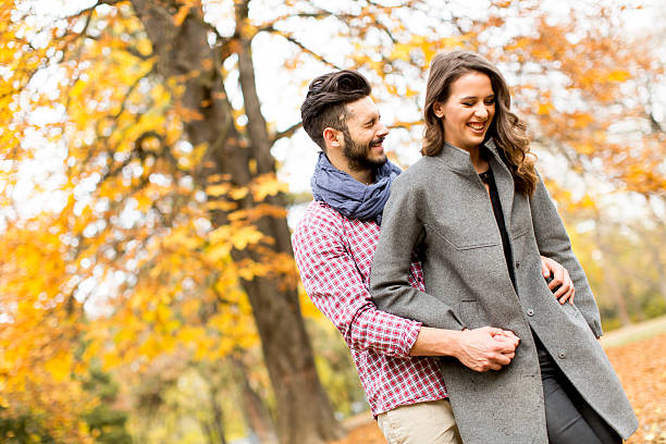istock Young couple in the autumn park 511874618