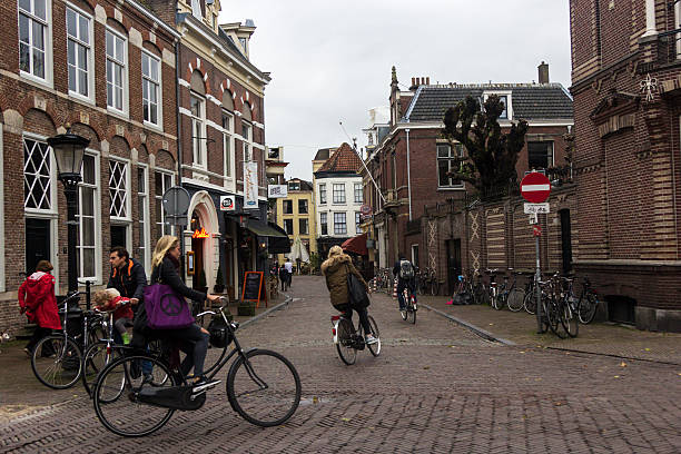 people on bikes in utrecht in holland - utrecht stockfoto's en -beelden