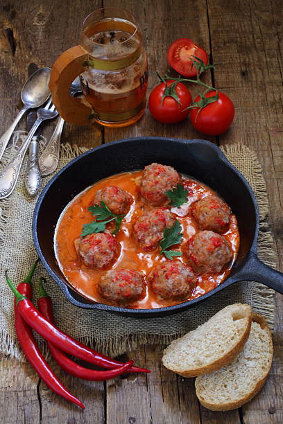 istock Meatballs with spicy peppers on a wooden table 511876094