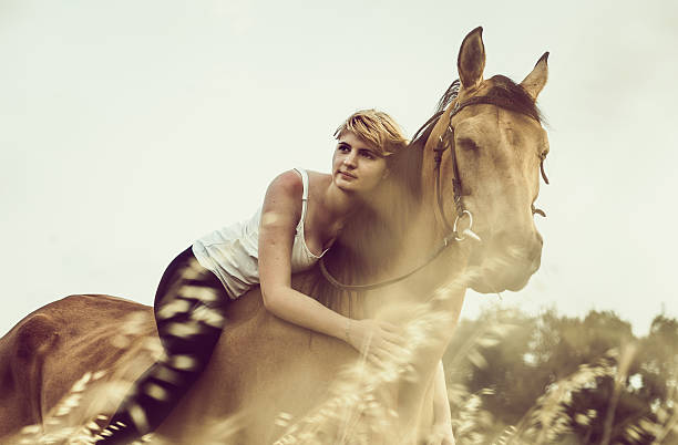 Young woman with a horse in nature - Retro toning