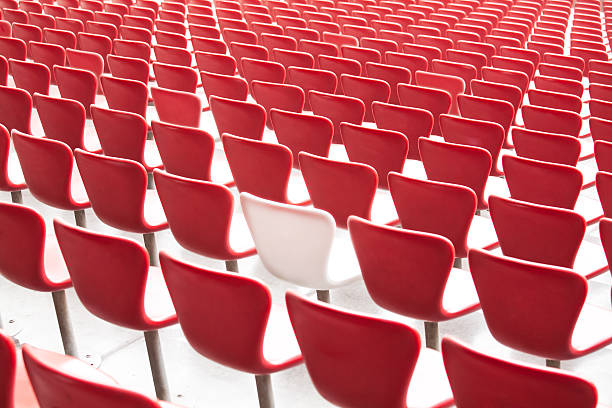 istock One white chair with lots of red ones 511876532
