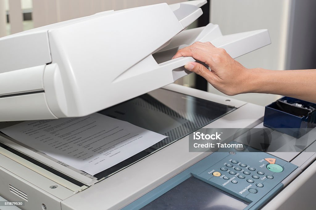 woman opening a photocopier Photocopier Stock Photo