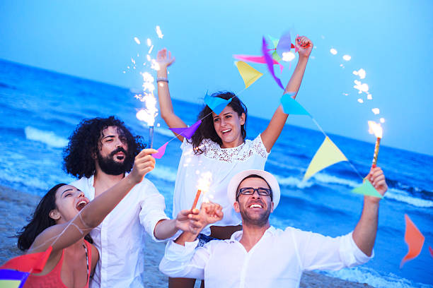 istock Friends celebrating with sparkler on the beach 511879556