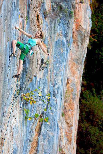 istock Extreme Sport Athlete hanging on vertical natural Wall 511880404