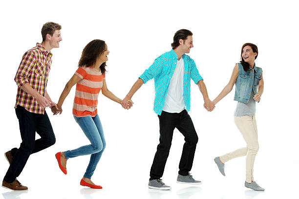 istock Group of people holding hands & walking 511883353