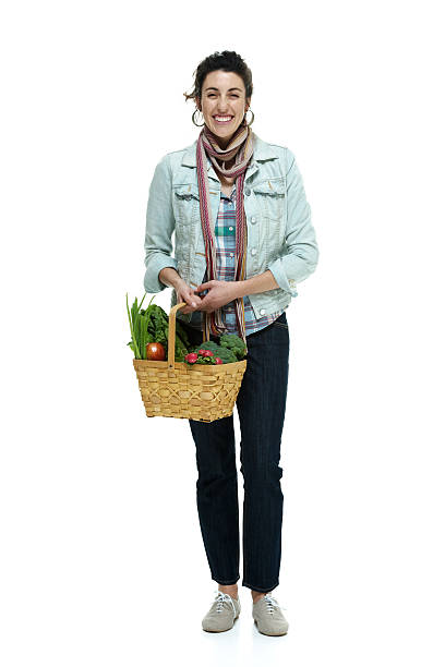 istock Cheerful woman holding vegetable basket 511883491