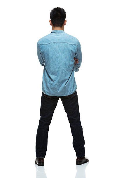 istock Rear view of man standing with arms crossed 511883561