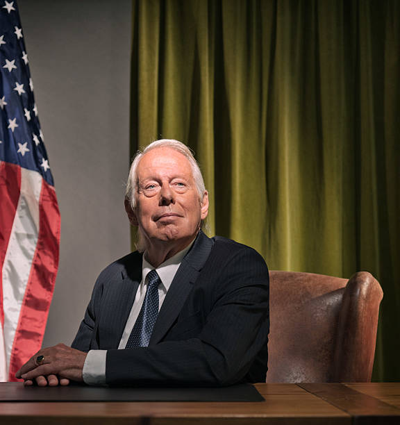 istock Big boss president sitting behind desk with american flag. 511884529