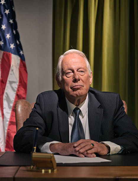 istock Big boss president sitting behind desk with american flag. 511884551