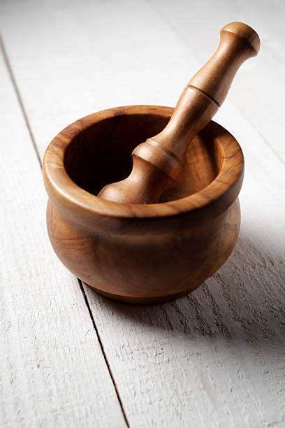 Wooden Pestle and Mortar on a white wooden table
