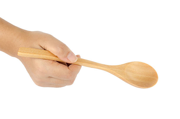 istock Woman's hand holding wooden spoon 511889195