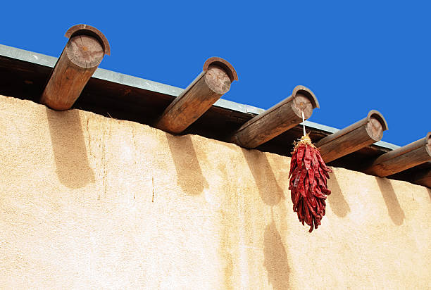 istock Chili Peppers Ristras on Adobe Wall with Vigas 511889673