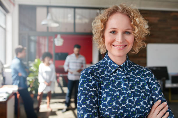 istock Female designer with colleagues in the background at office 511917132