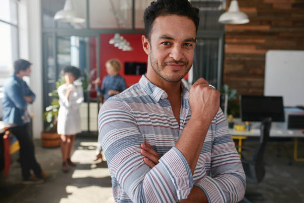 istock Confident young man standing in his office 511917260