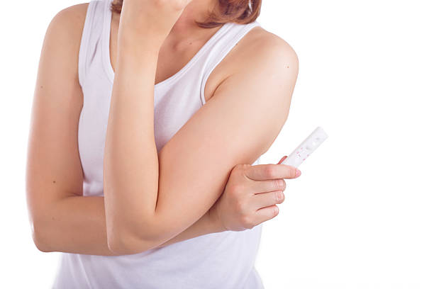 istock Young women shown pregnancy test concept isolated white backgrou 511917584