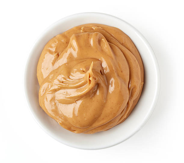 istock Peanut butter in round dish isolated on white background 511918410