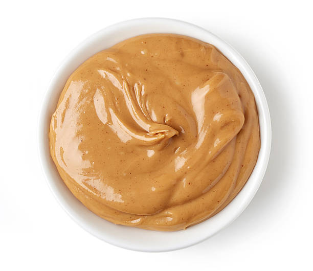 istock Peanut butter in round dish isolated on white background 511918434