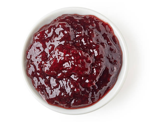 istock Summer berries marmalade in round dish isolated on white background 511918536