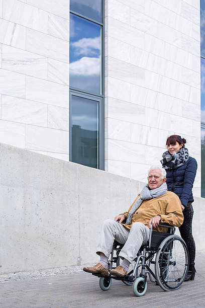 istock Senior assistant pushing a wheelchair 511918964