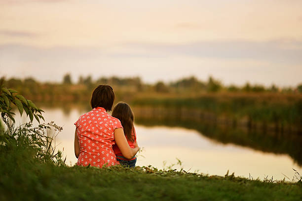 istock girl sitting with her mother 511920640