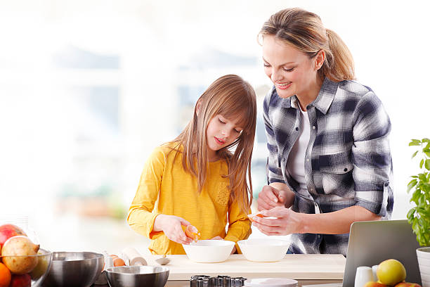 istock Mother and daugther baking together 511920978