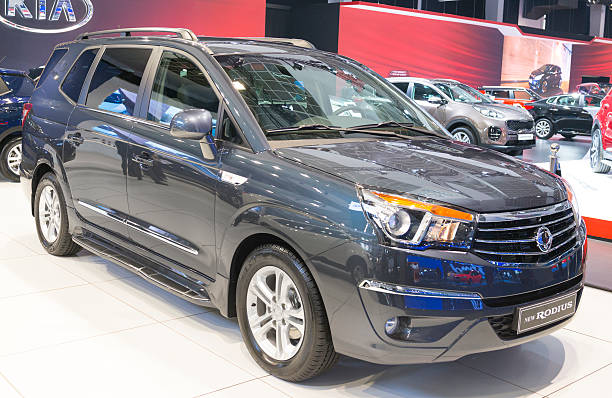 Brussels, Belgium - Januari 12, 2016: SsangYong Rodius crossover MPV front view. The car is on display during the 2016 Brussels Motor Show. The car is displayed on a motor show stand, with lights reflecting off of the body. There are people looking around and other cars on display in the background.