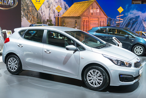 Brussels, Belgium - Januari 12, 2016: Silver Kia Cee'd compact hatchback car side view. The car is on display during the 2016 Brussels Motor Show. The car is displayed on a motor show stand, with lights reflecting off of the body.