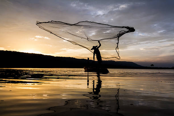 istock Silhouette of asia fisherman 511925646