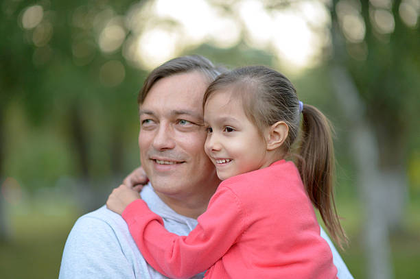 istock father holding his daughter in his arms 511926072