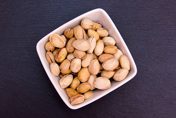 istock Pistachios on a square bowl on top slate 511927896