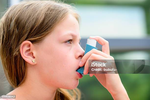 Girl Uses An Inhaler During An Asthma Attack Stock Photo - Download Image Now - Allergy, Allergy Medicine, Asthma Inhaler