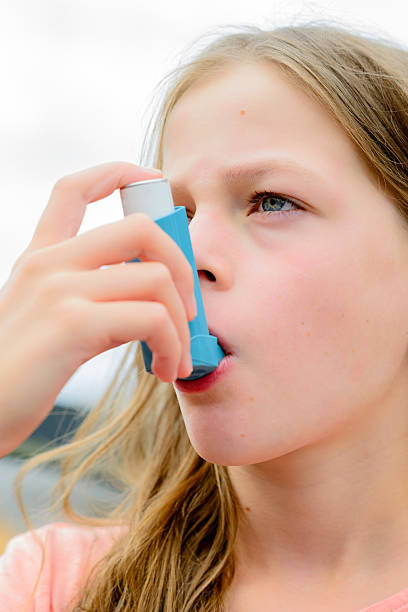 istock Girl having asthma using the asthma inhaler 511928652