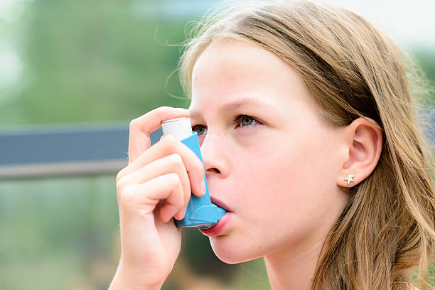 istock Girl having asthma using the asthma inhaler 511929048