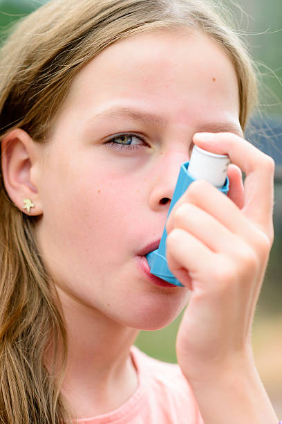 istock Girl having asthma using the asthma inhaler 511929182