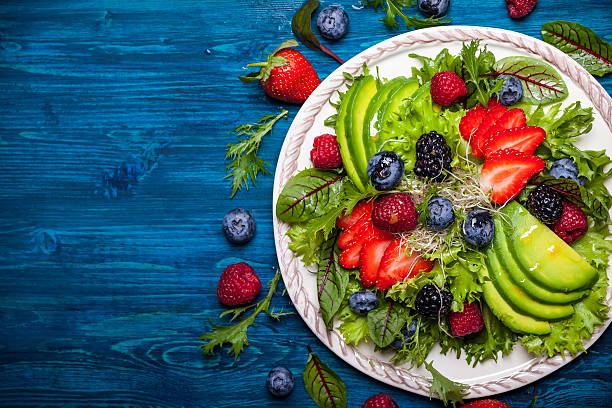 Berry salad Mixed salad leaves with berries, avocado and honey-mustard dressing mustard fruits stock pictures, royalty-free photos & images