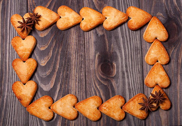 istock frame from heart shaped cookies on wooden table 511932338