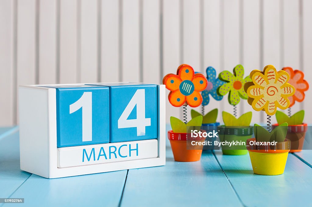 March 14th. Image of march 14 wooden color calendar with March 14th. Image of march 14 wooden color calendar with flower on white background.  Spring day. March - Month Stock Photo