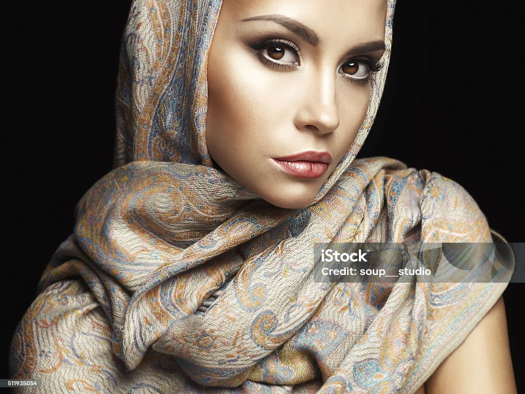 Beautiful lady wrapped in a shawl Studio fashion portrait of beautiful lady wrapped in a orient shawl Arabia Stock Photo