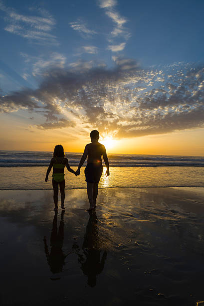 istock Children bathing on the beach at dusk 511937174