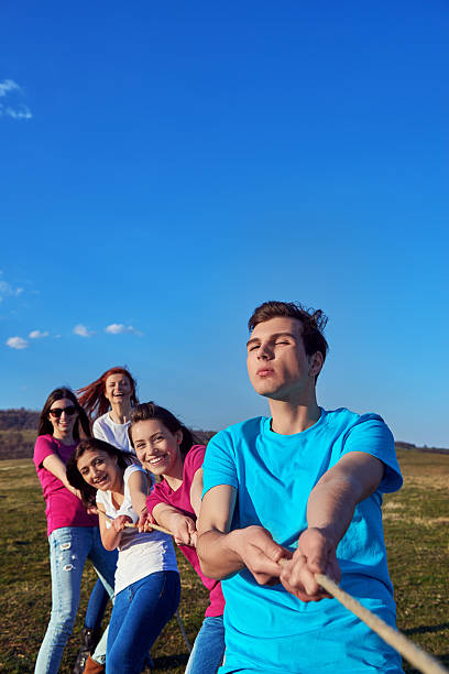 istock teenagers playing tug of war 511937610