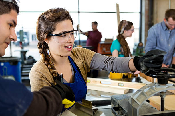 istock Young Hispanic woman uses lathe in workshop 511938558