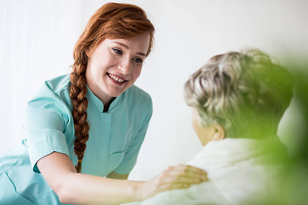 istock Female medic supporting senior woman 511940594