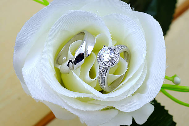 istock wedding rings with rose flowers 511940782