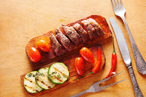 istock Delicious beef steak with vegetable over wooden table 511941680