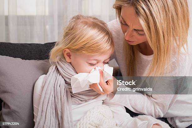 Little Girl With Cold And Blowing Her Nose Stock Photo - Download Image Now - Child, Cold And Flu, Sneezing