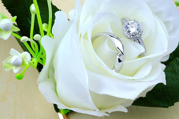 istock wedding rings with rose flowers 511942376