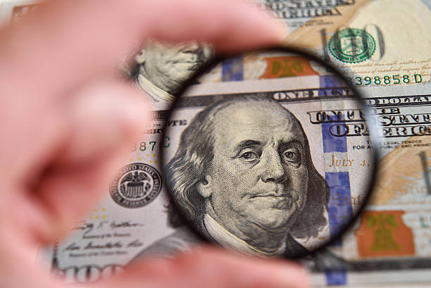 istock Dollar banknote through magnifying lens (corruption, lobbying, i 511945048