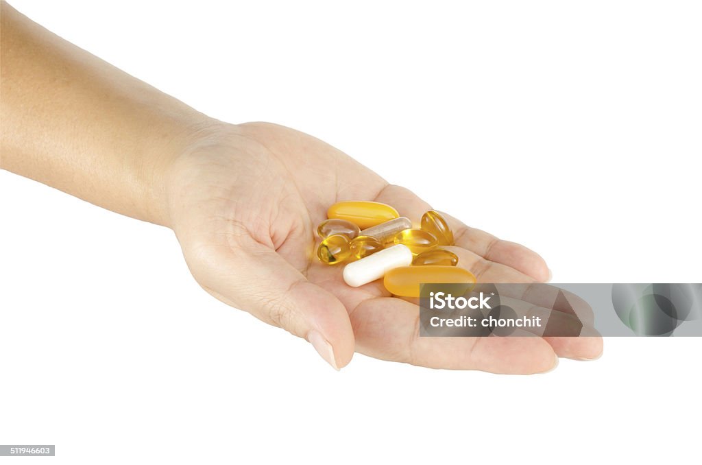 Vitamin in woman's hand Vitamin in woman's hand isolate on white background Adult Stock Photo